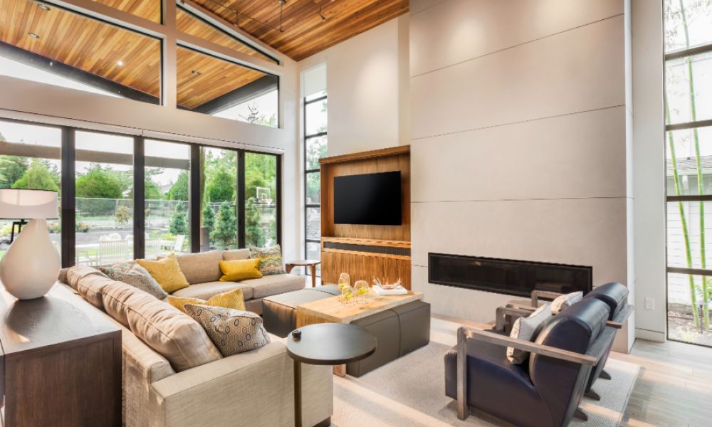 A contemporary living room showcasing a fireplace, elegant wood ceiling, and furniture.