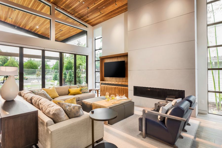 A contemporary living room showcasing a fireplace, elegant wood ceiling, and furniture.